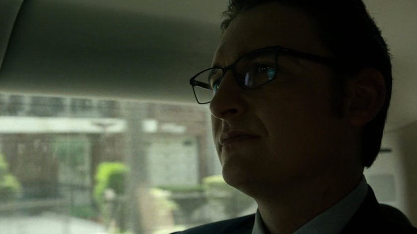 Wesley in car driving on New York street.