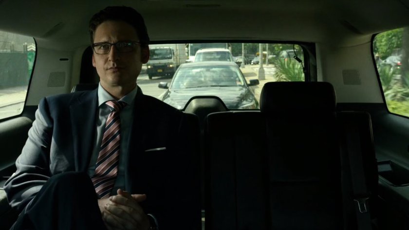 Wesley in car driving on New York street.