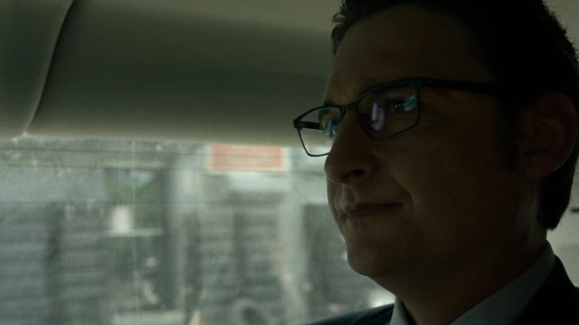 Wesley in car driving on New York street.