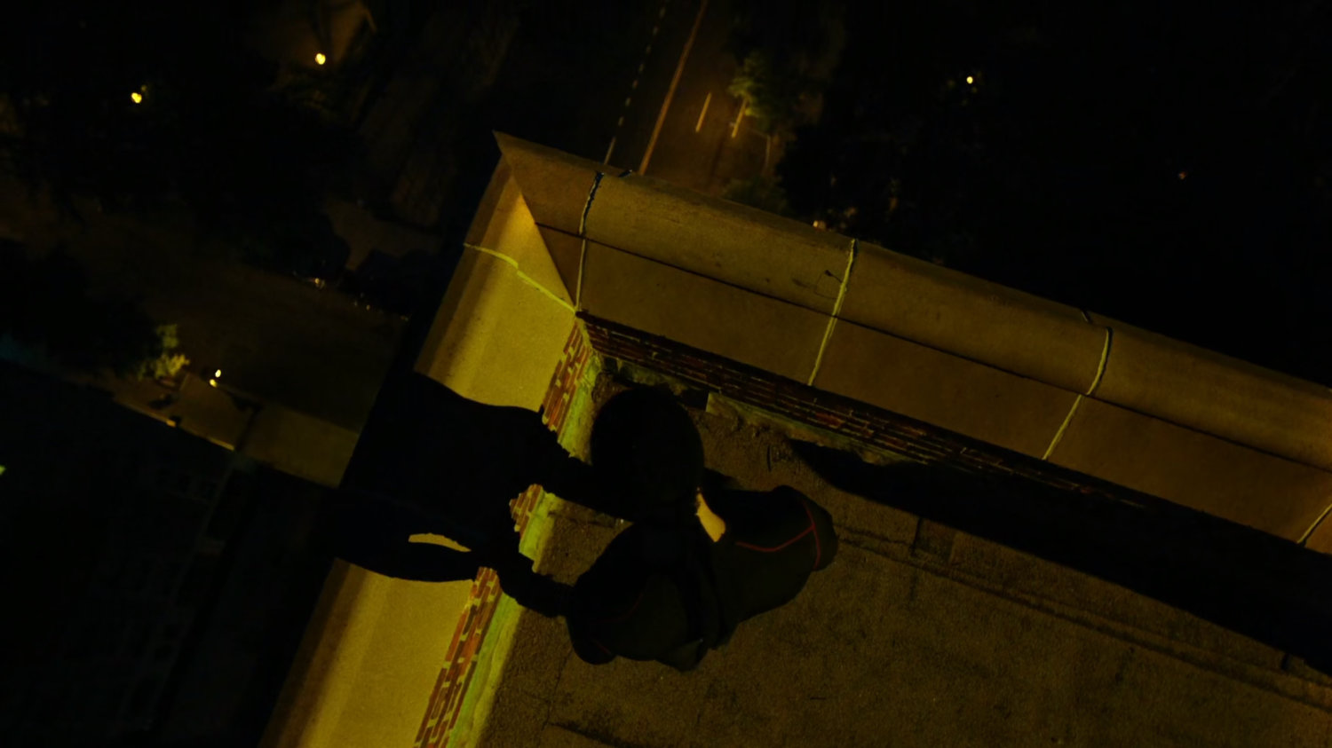 Daredevil on a rooftop listening to the city.