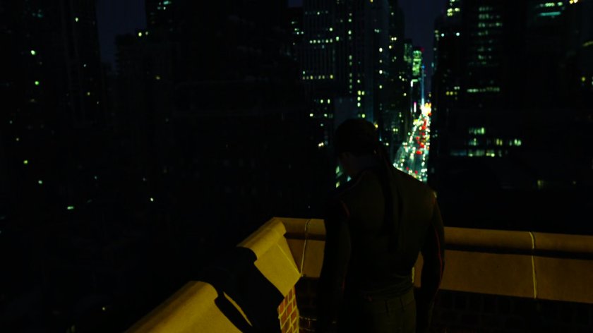 Daredevil on a rooftop listening to the city.