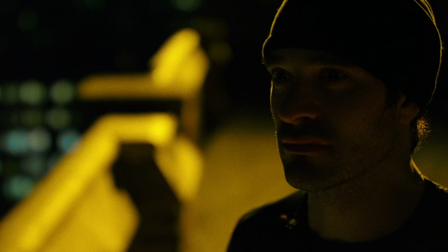 Daredevil on a rooftop listening to the city.