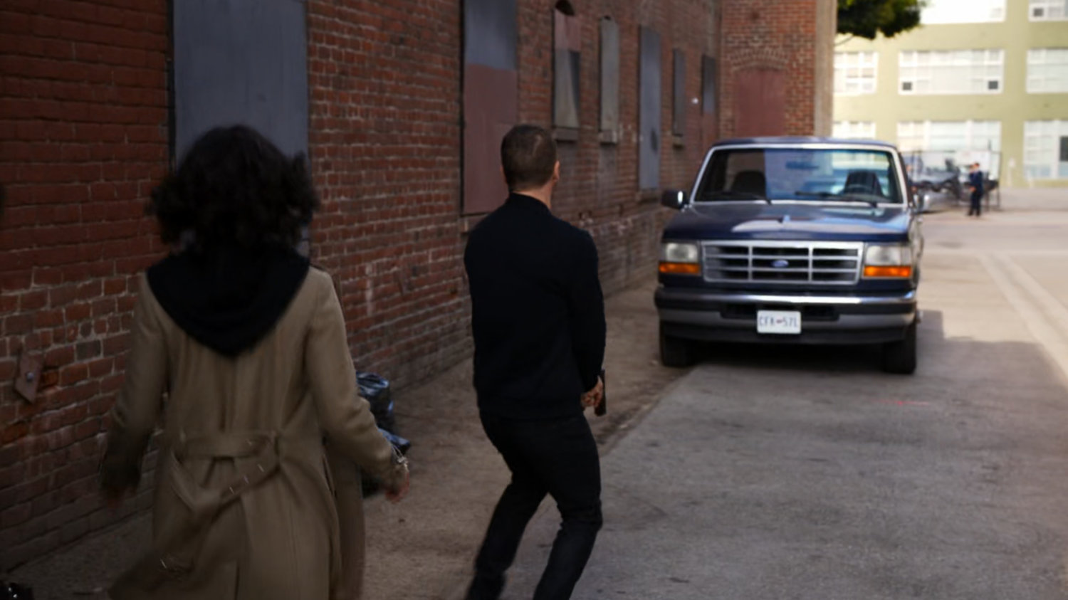 Hunter and Raina in a brick alley in Vancouver.