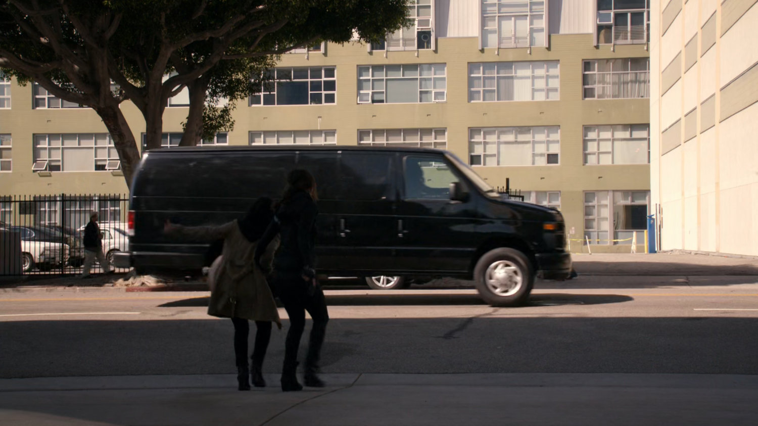 Raina and Skye on Vancouver sidewalk looking at black van.