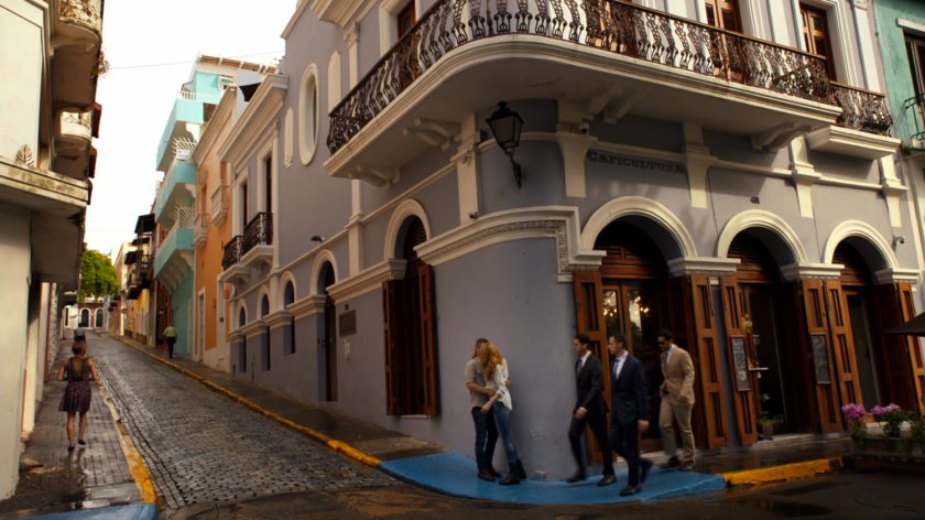 Bobbi and Hunter kiss on street corner in San Juan.