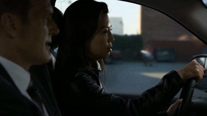 Coulson and May driving on street.