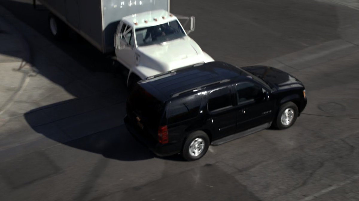 Black SHIELD SUV t-boned by white box truck.