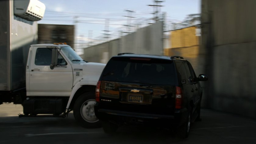 Black SHIELD SUV t-boned by white box truck.