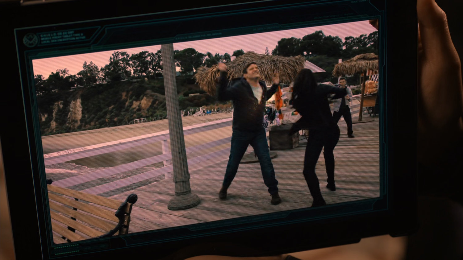 Video screen of Sif fighting man on pier.