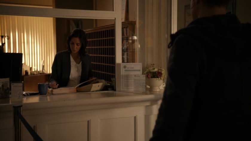 A nurse behind the counter at Faro hospital.