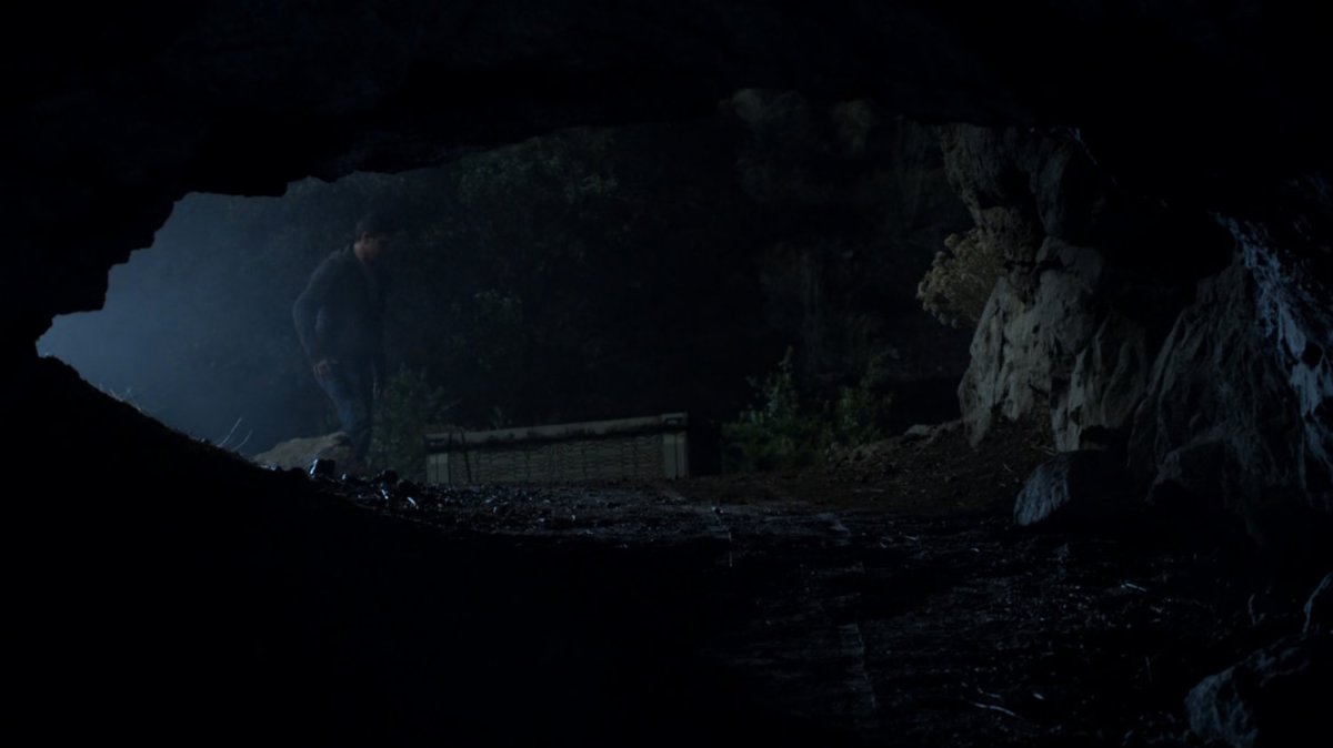 Vin-tak by crate in dark cave.