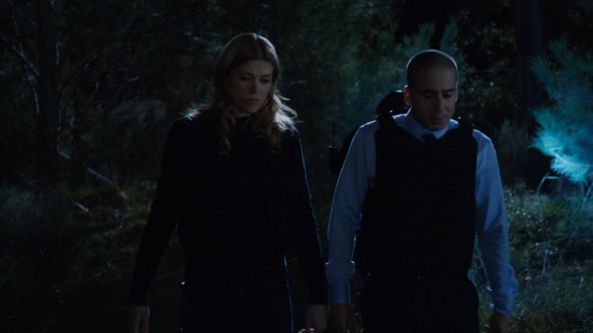 Bobbi and Agent Calderon in the woods outside Fury's cabin.