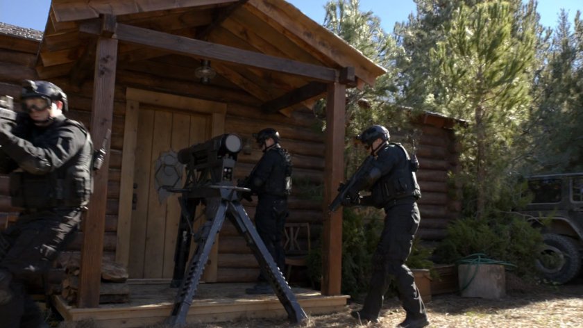 SHIELD Agents set up battering ram at the door of Fury's Cabin.