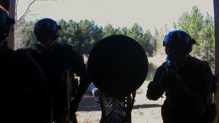 SHIELD Agents set up battering ram at the door of Fury's Cabin.