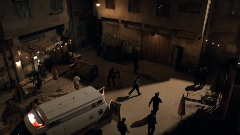Nighttime shot of agents in dirt courtyard in Bahrain.