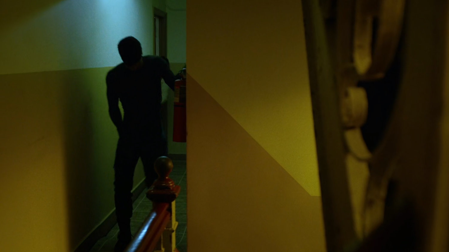 Matt in hall of Claire's apartment building.
