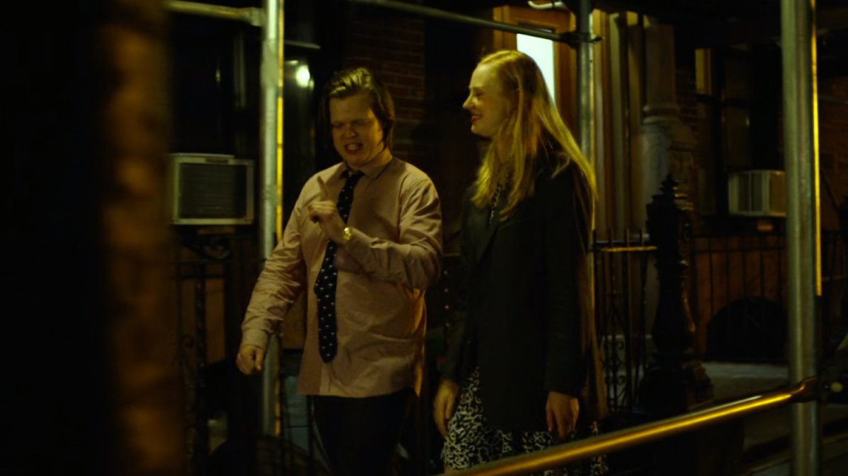 Foggy & Karen walk on sidewalk at night.