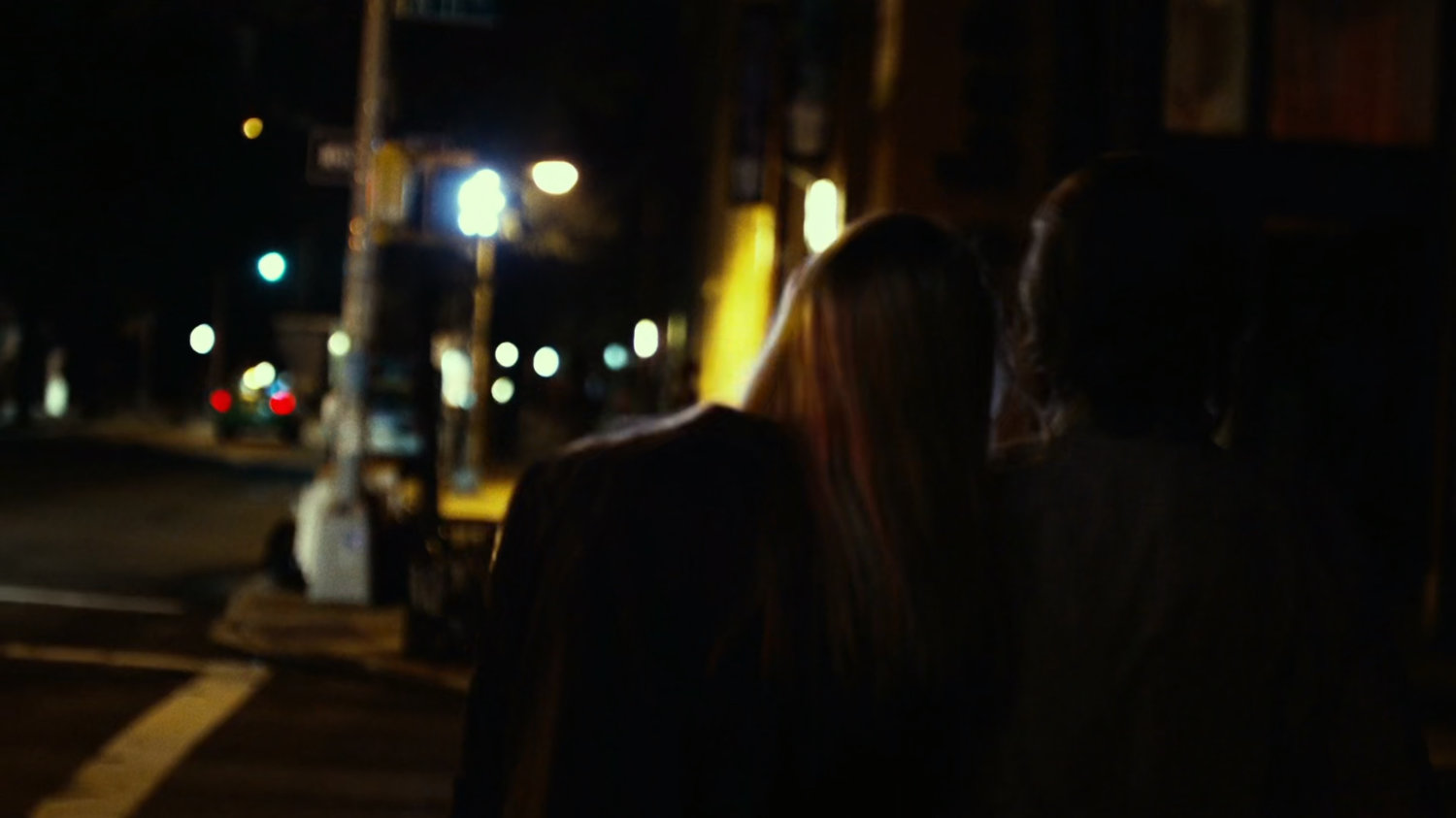 Foggy & Karen walk on sidewalk at night.