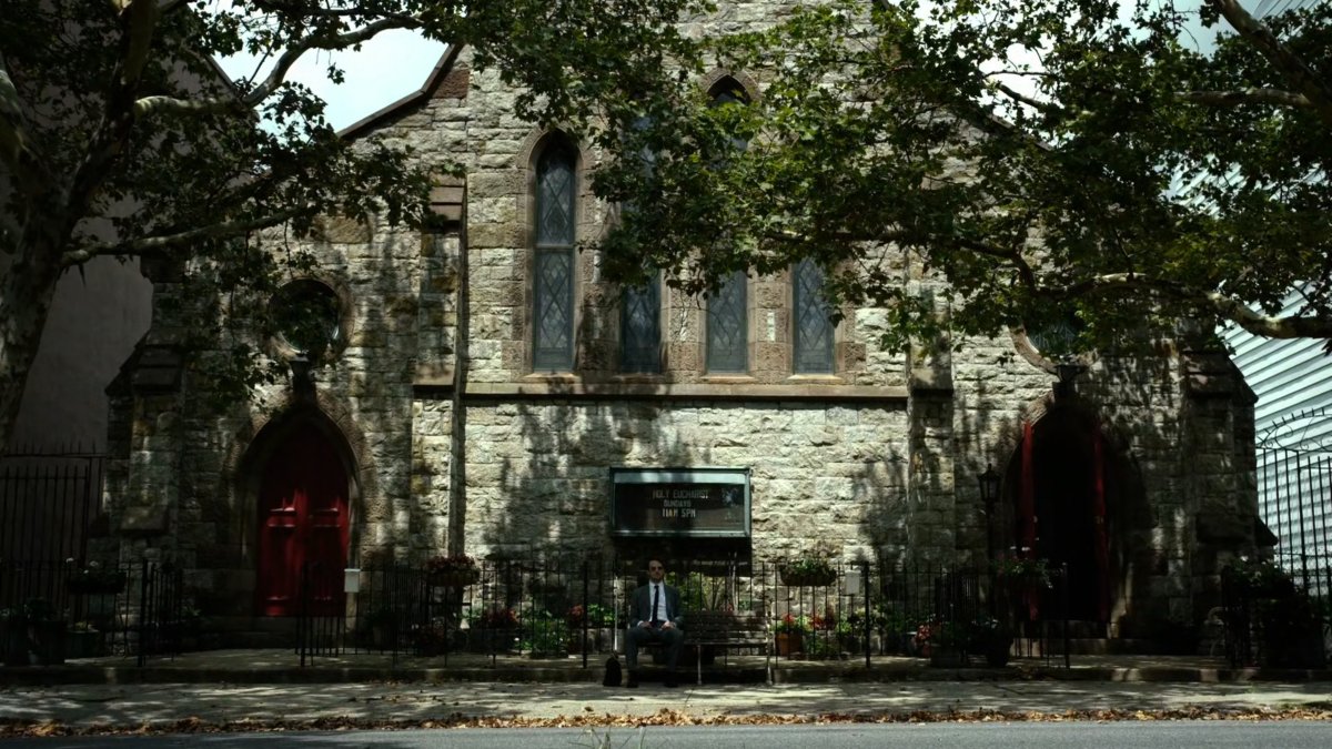 Matt sits on bench outside of church.
