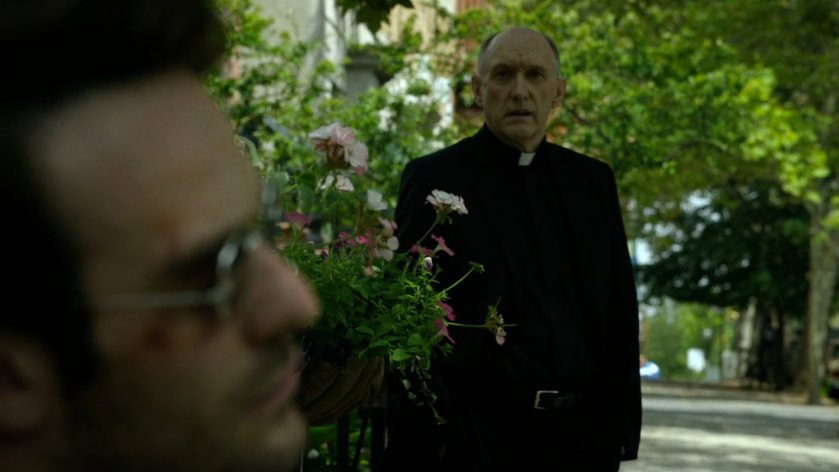 Father Lantom approaches Matt outside church.