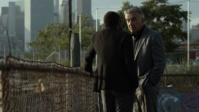 Ben and Silvio talk in river side lot.