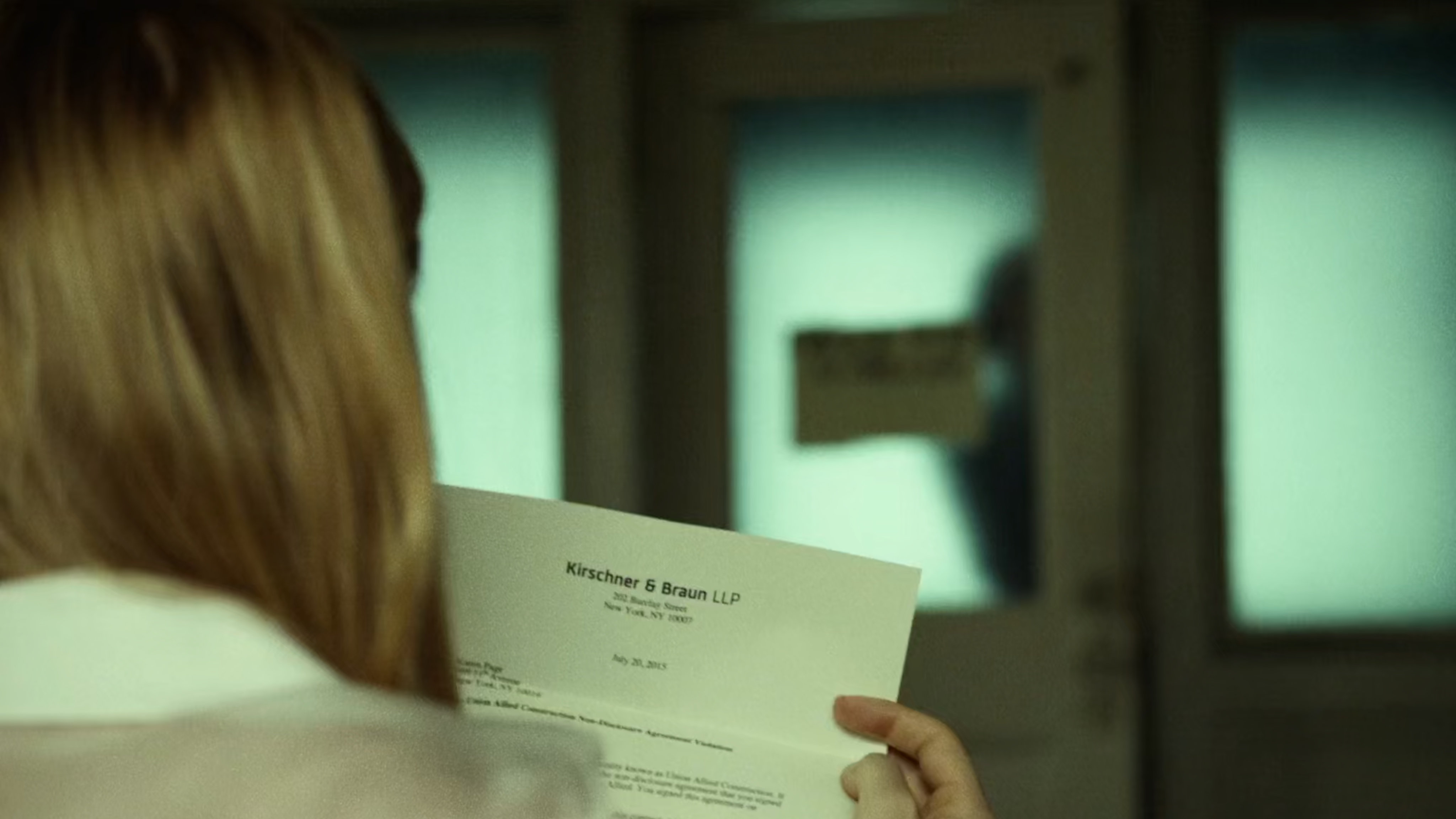 Karen looks at letterhead from Kirschner & Braun.