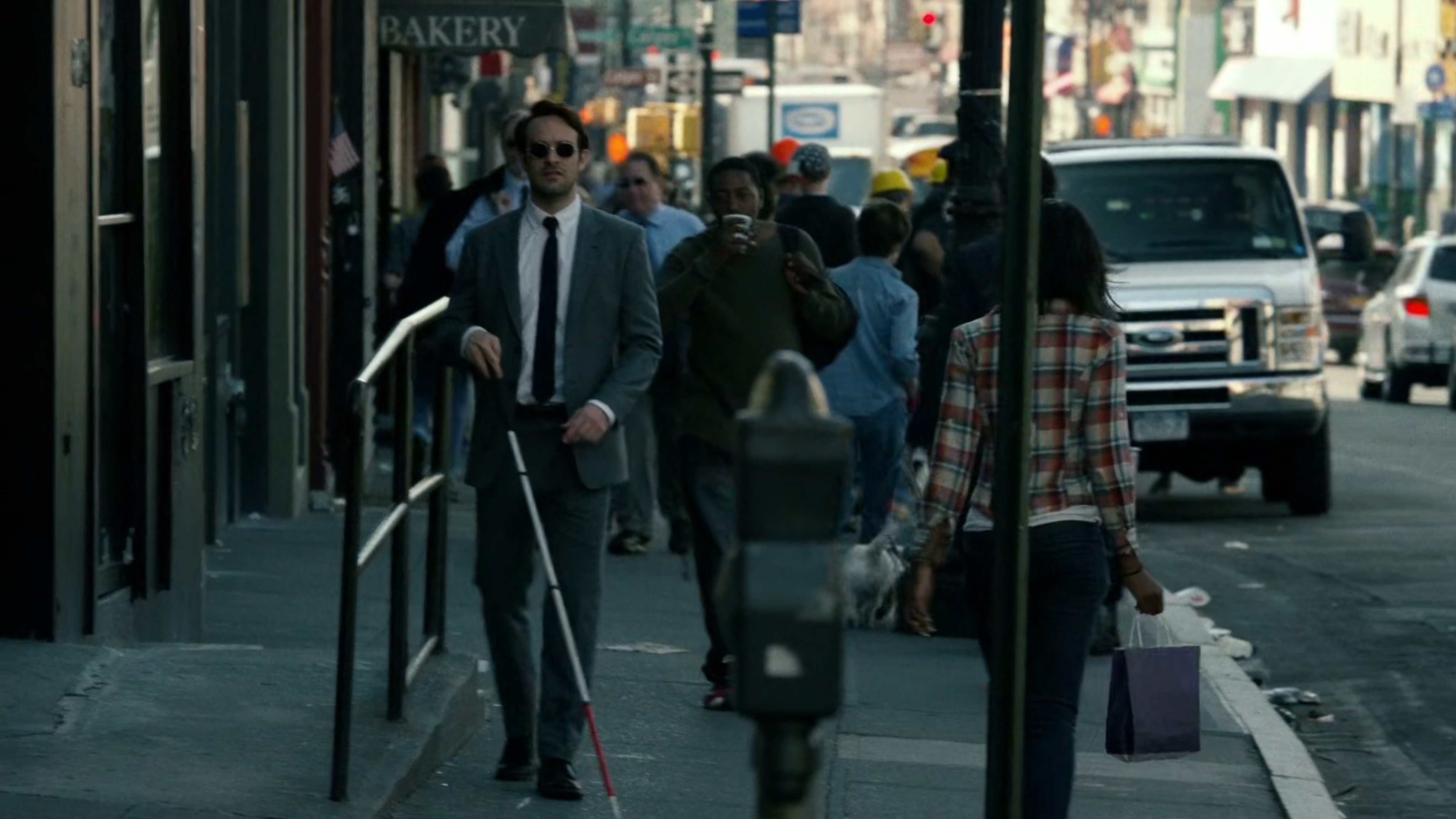 Matt follows Wesley along crowded sidewalk.