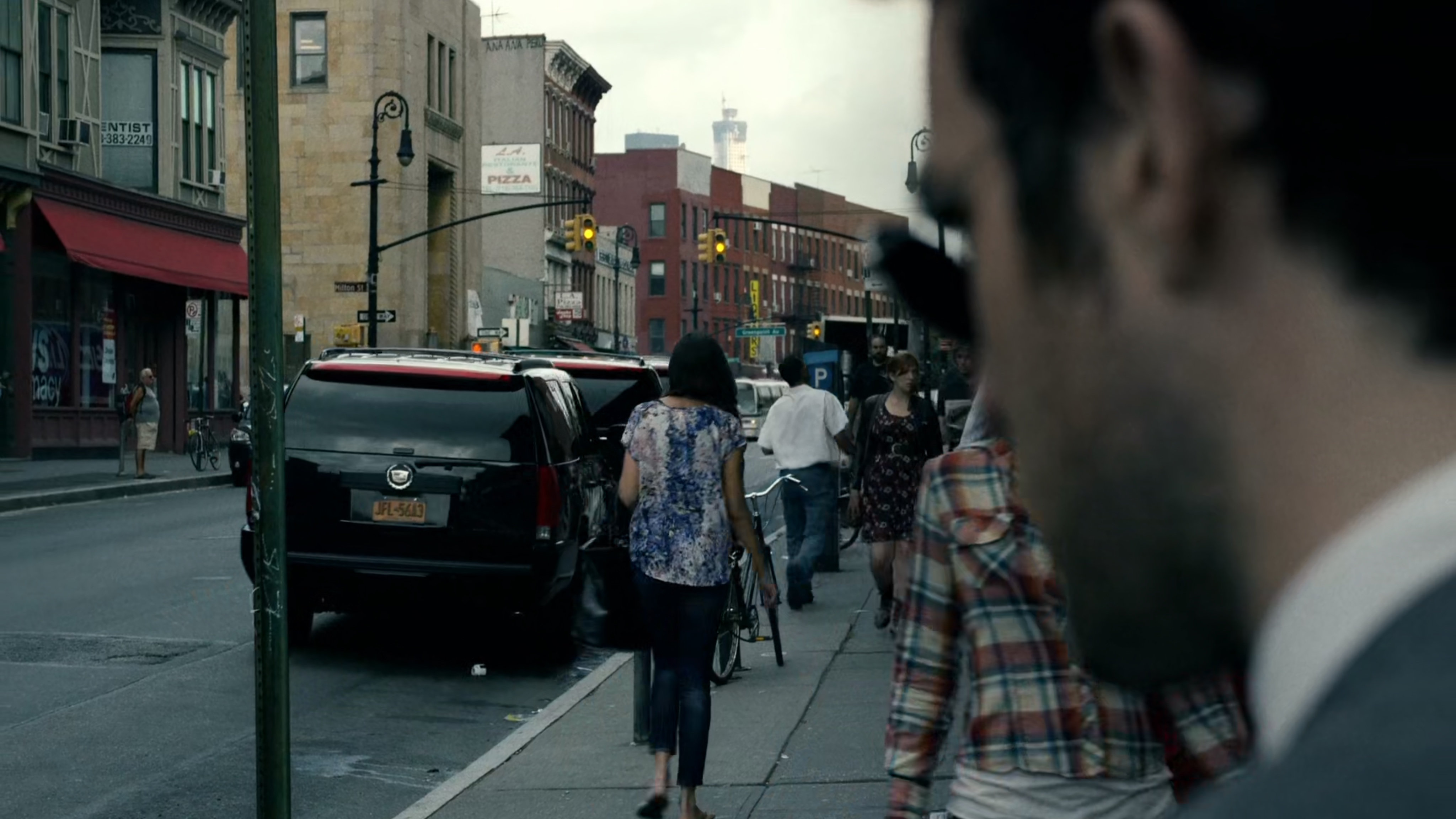Matt watches three black SUVs pull away from curb.