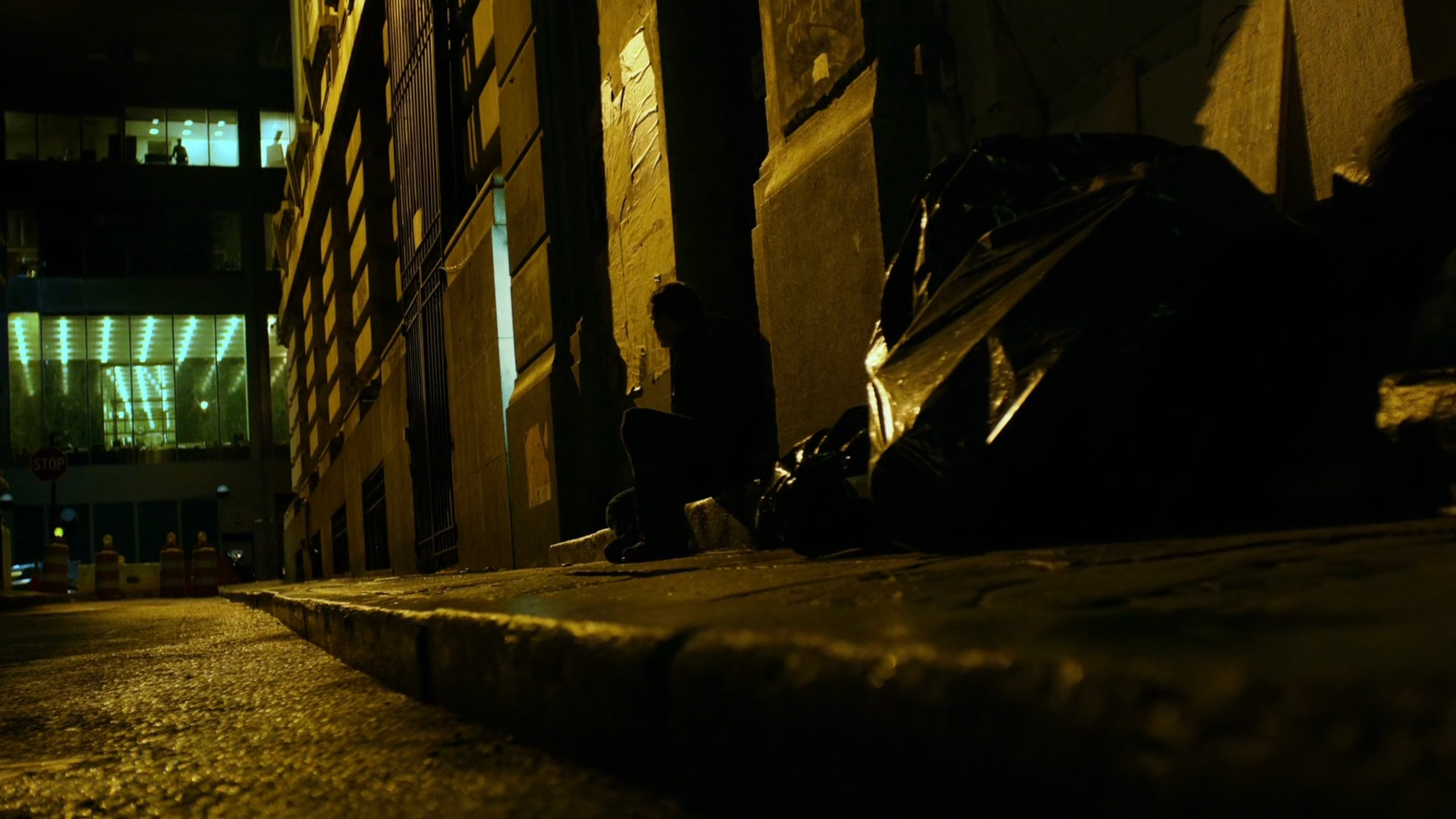 Man confronts female juror on sidewalk at night.