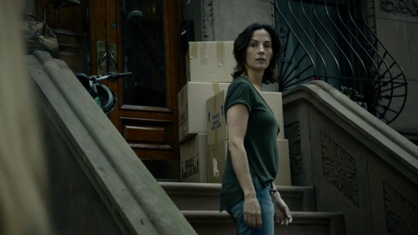 Mrs Fisher on steps of brownstone.