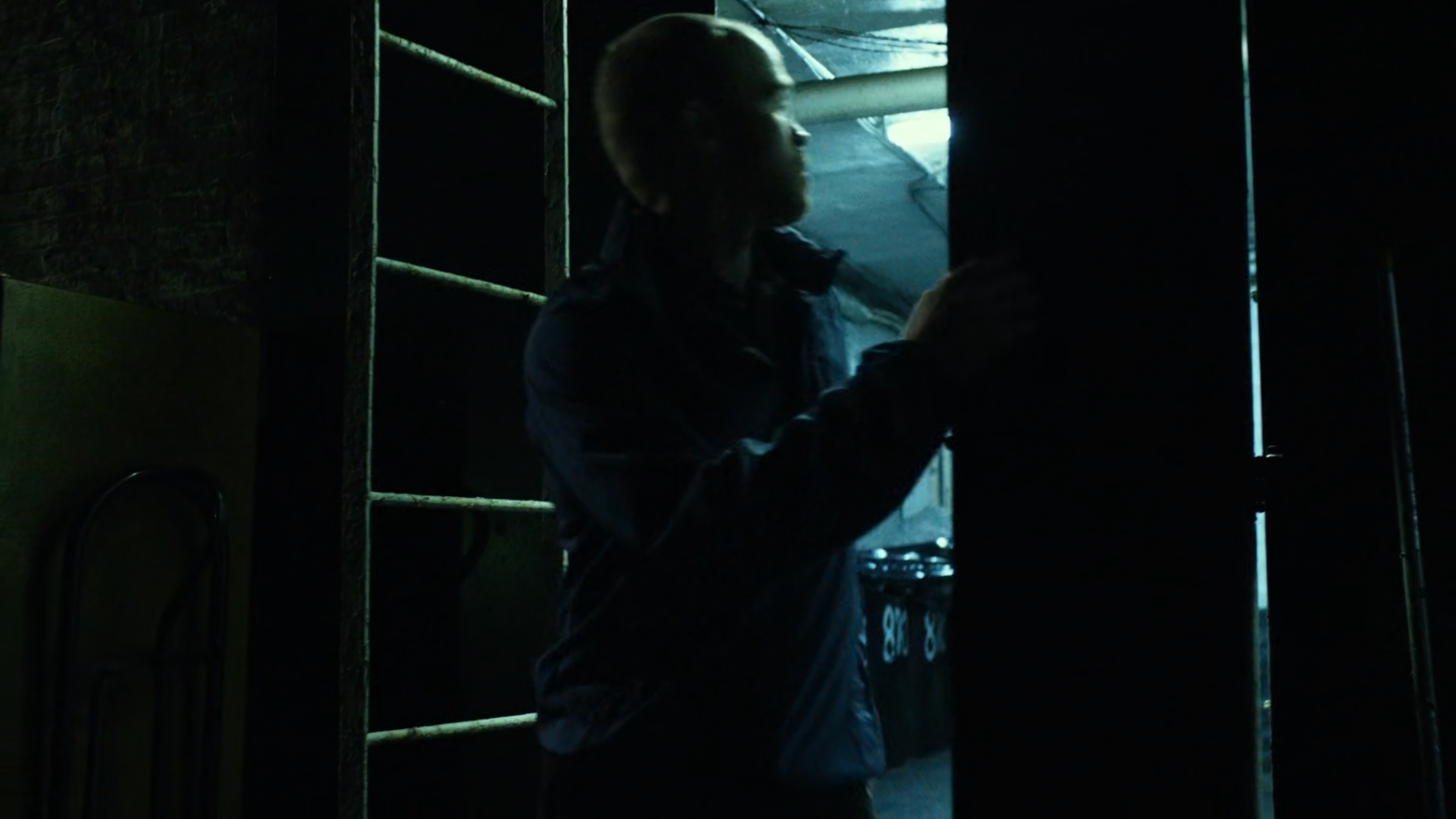 Healy exits building by dark alley.