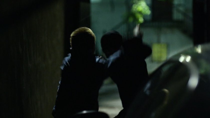 Daredevil fights Healy in dark alley.