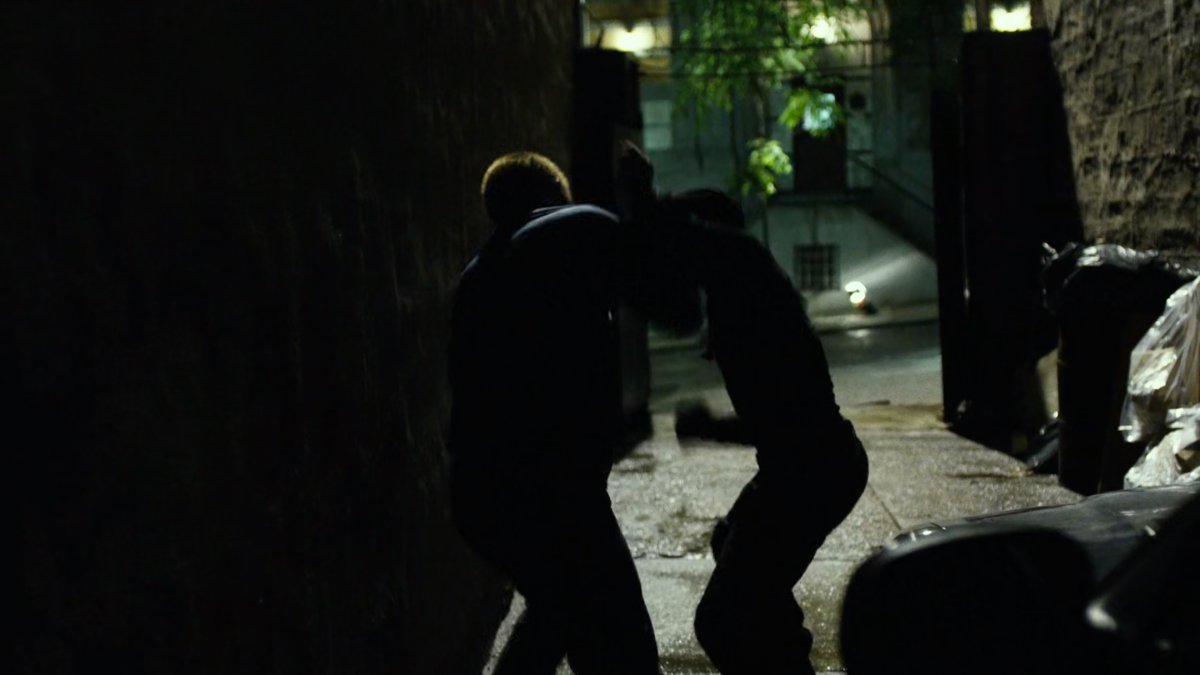 Daredevil fights Healy in dark alley.
