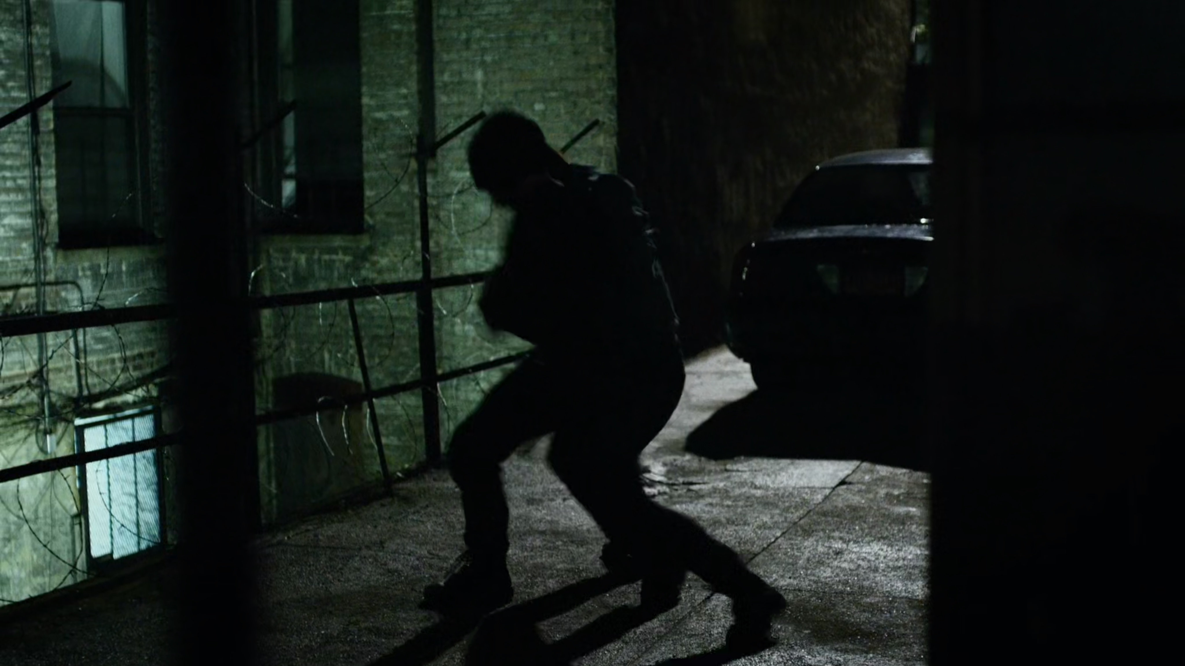 Daredevil fights Healy in dark alley.