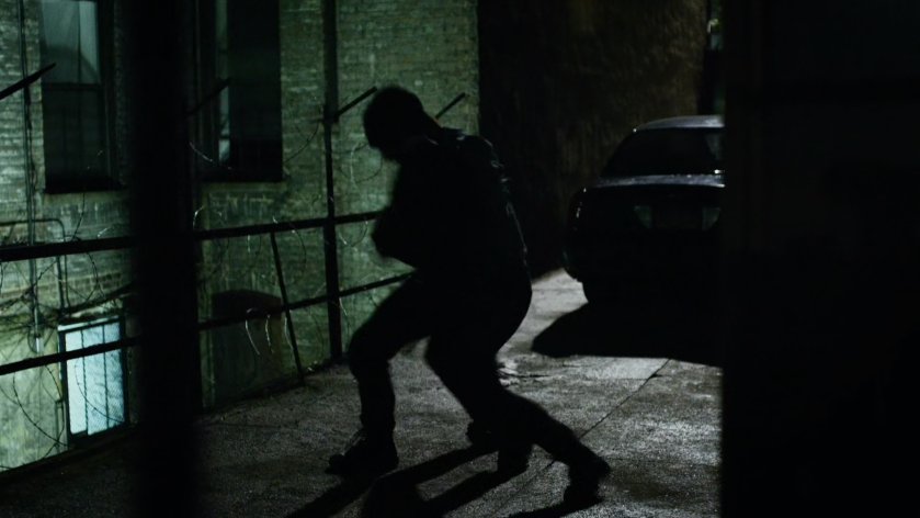 Daredevil fights Healy in dark alley.