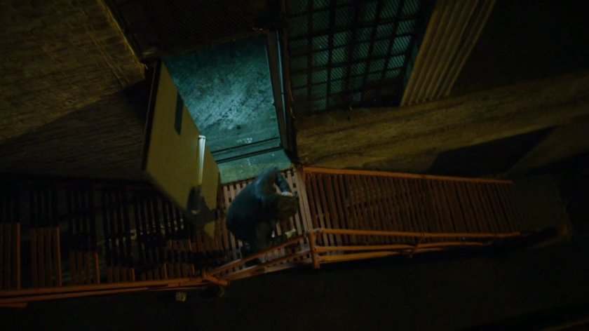 Man runs out of building into alley.