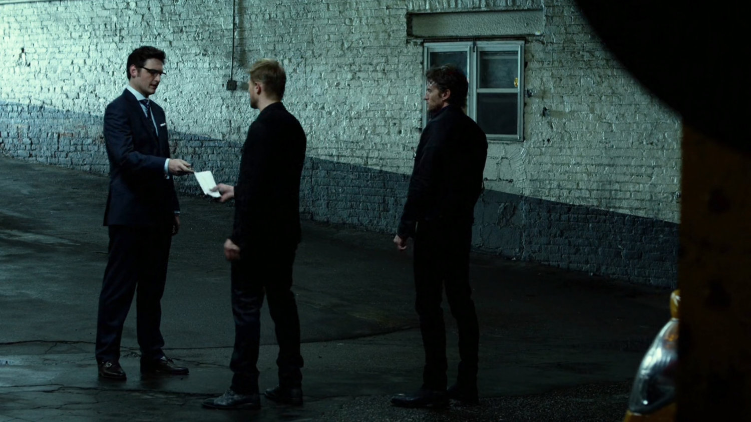 Wesley talks to Ranskahov brothers inside Veles Taxi garage.