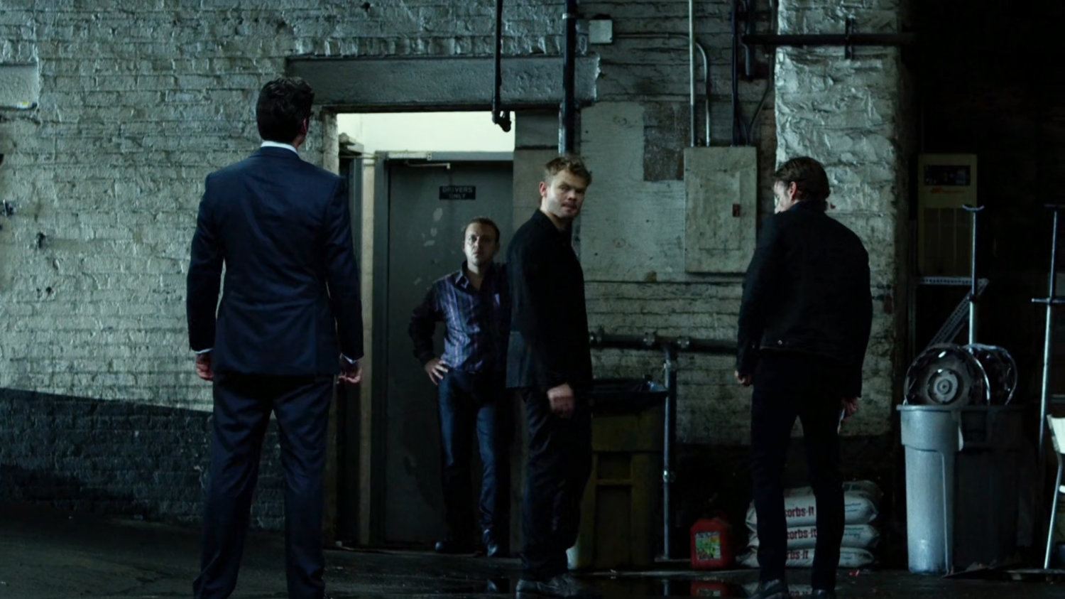 Wesley talks to Ranskahov brothers inside Veles Taxi garage.