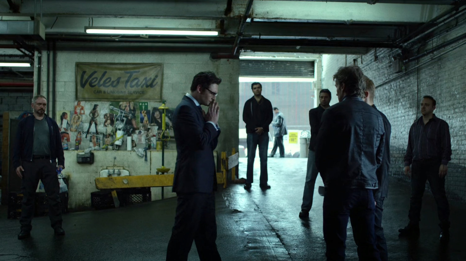 Wesley talks to Ranskahov brothers inside Veles Taxi garage.
