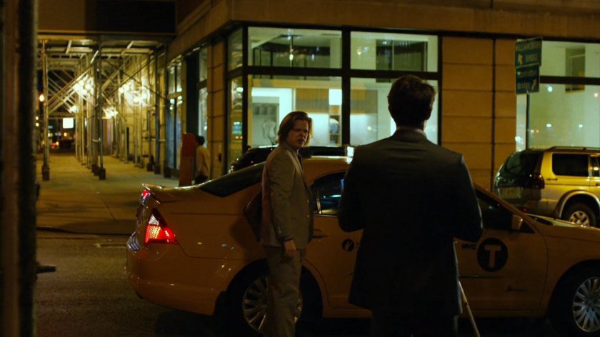 Foggy gets into cab at intersection at night.