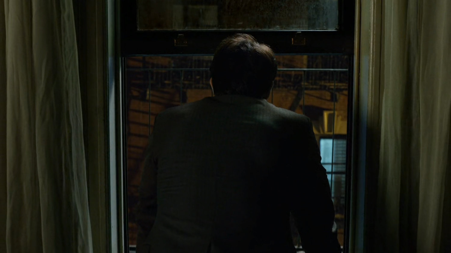 Matt listens out window of Claire's coworker's apartment.