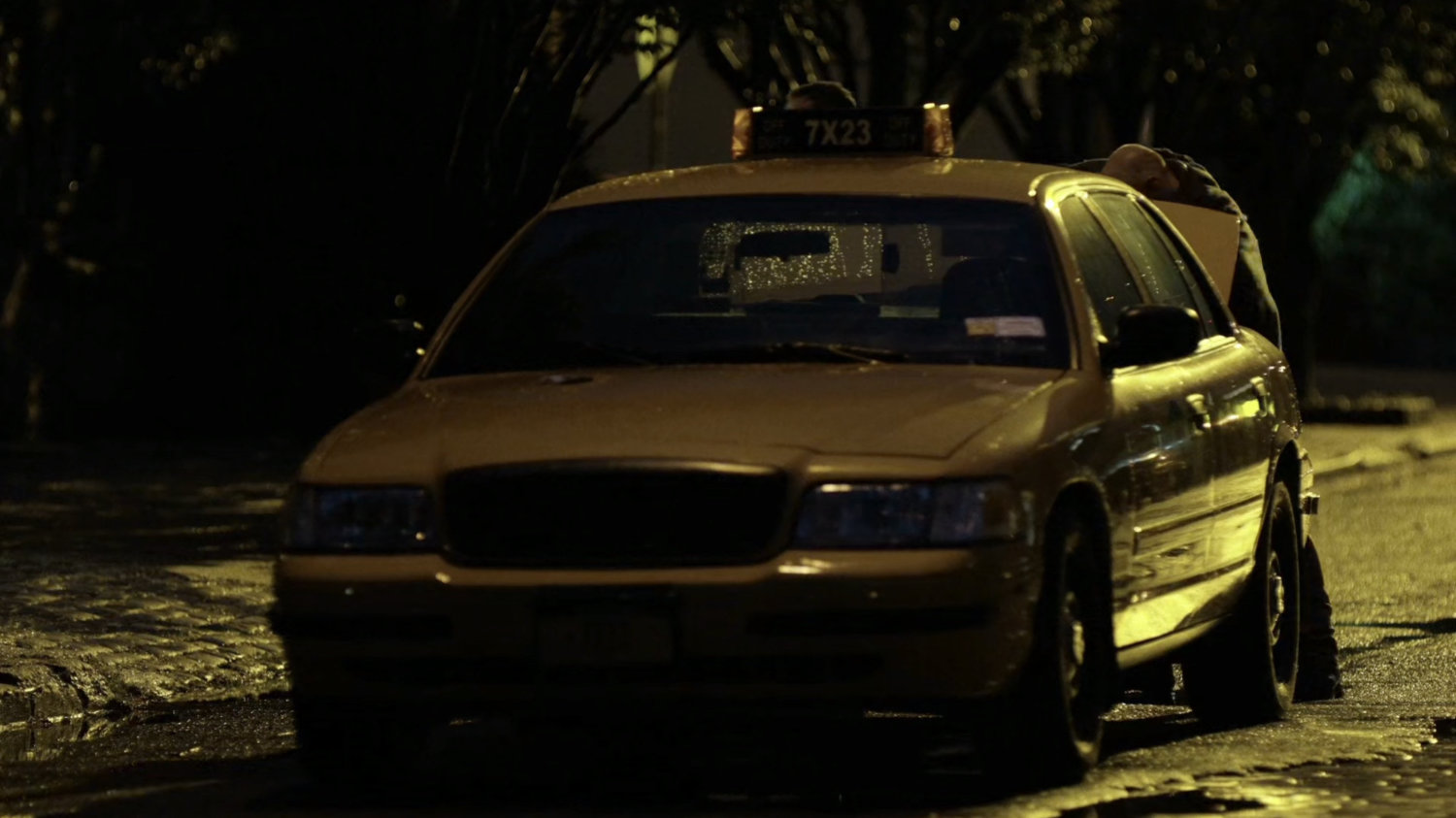 Cab parked on street outside Claire's coworker's apartment.