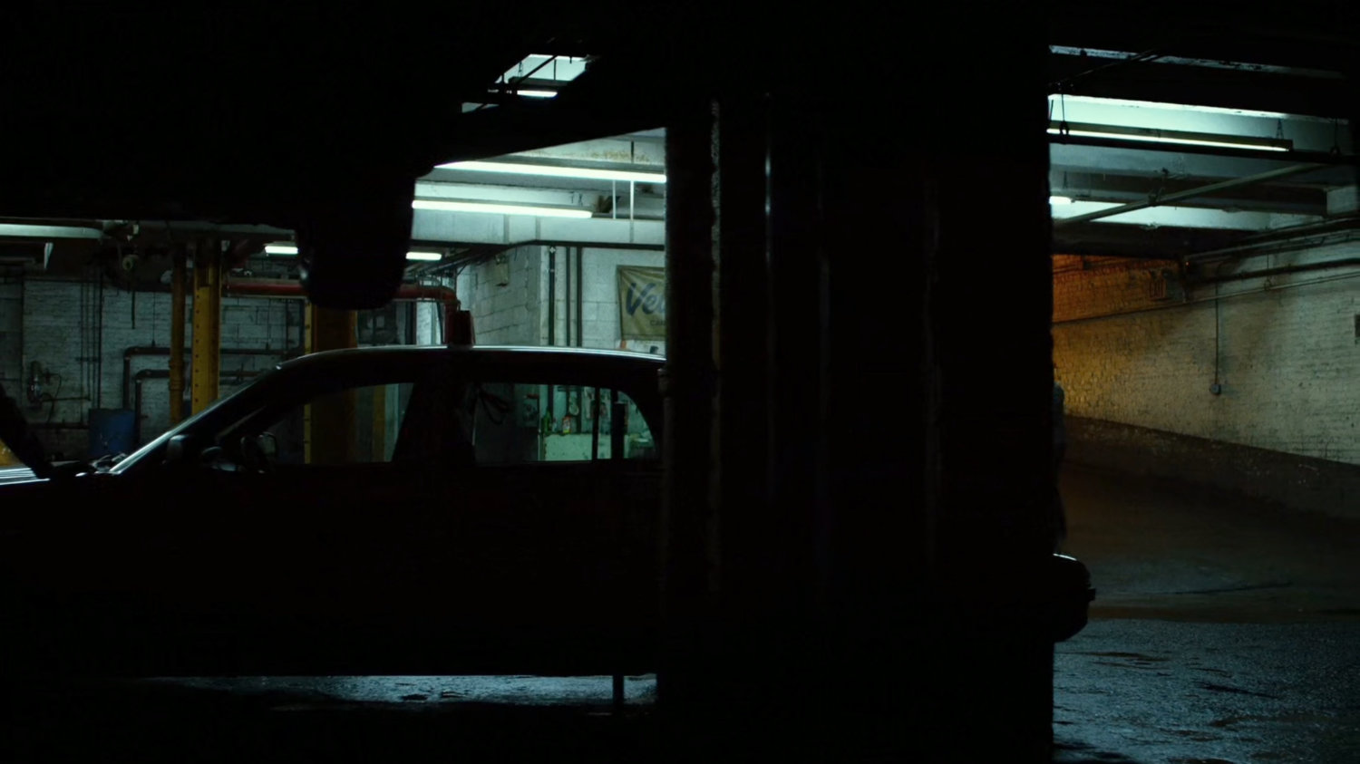 Interior of Veles Taxi garage, night.
