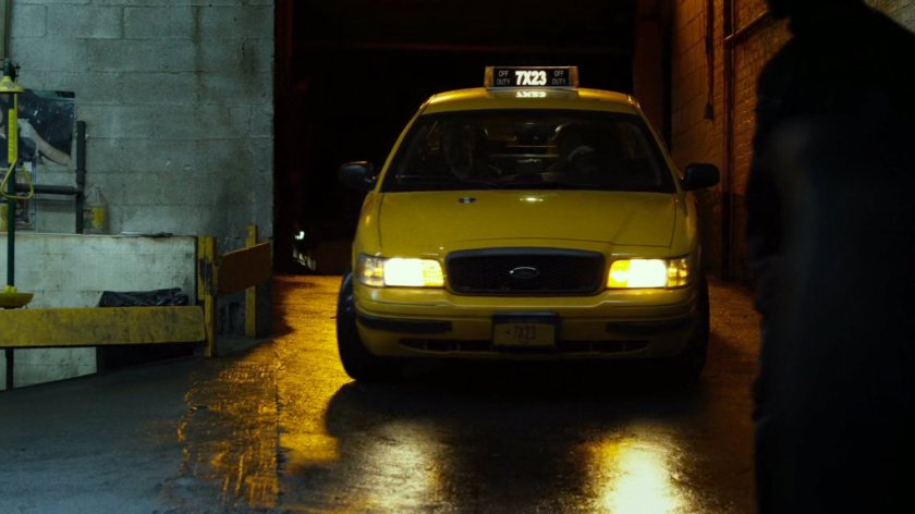 Cab enters Veles Taxi garage, night.