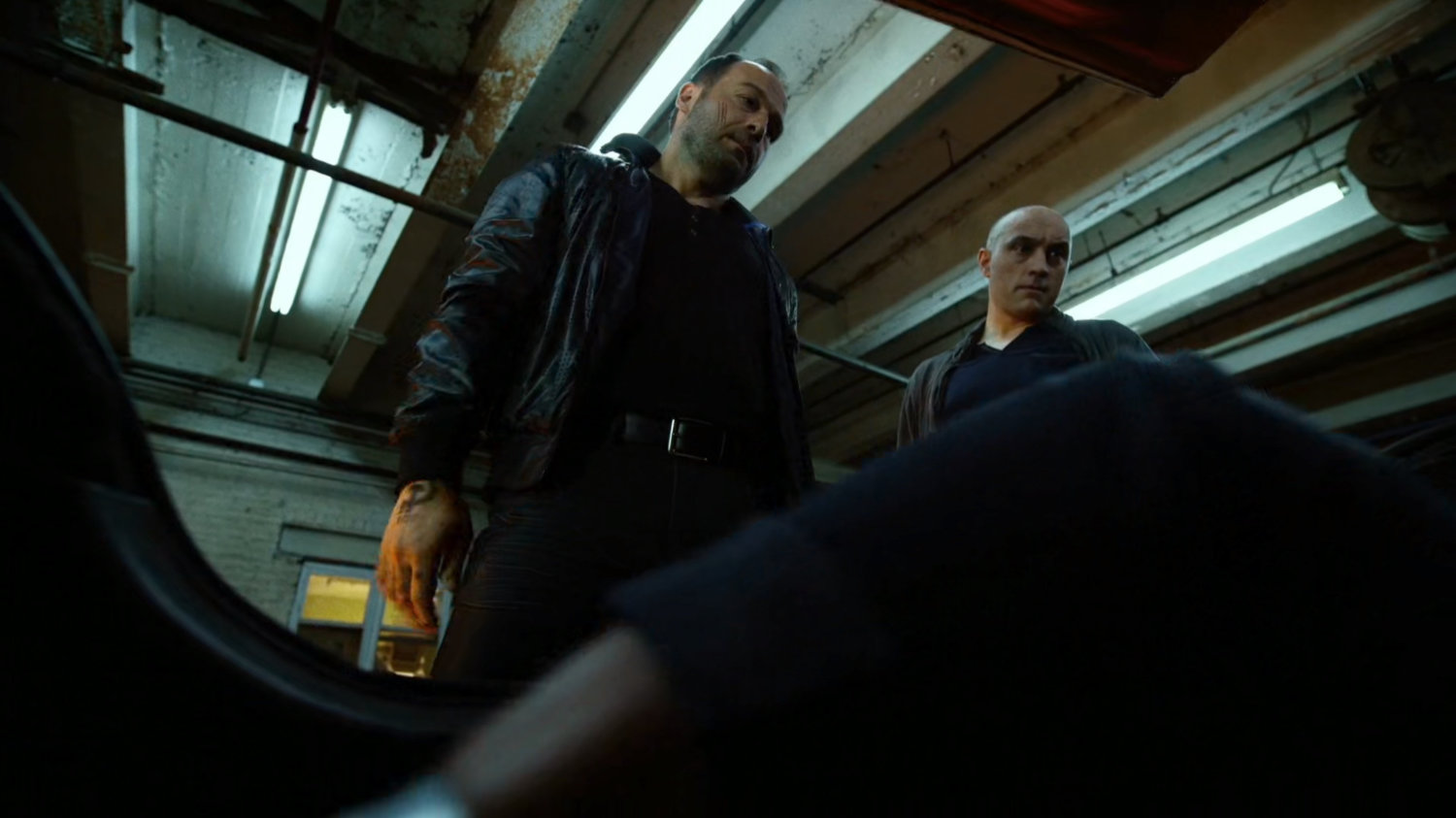 Russian mobsters looking in trunk of cab.