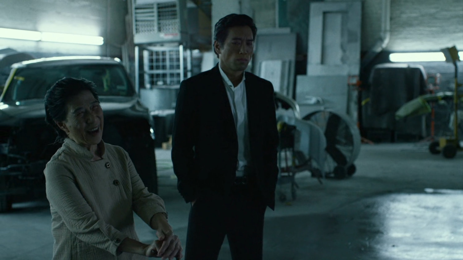 Madame Gao and Nobu in body shop garage.