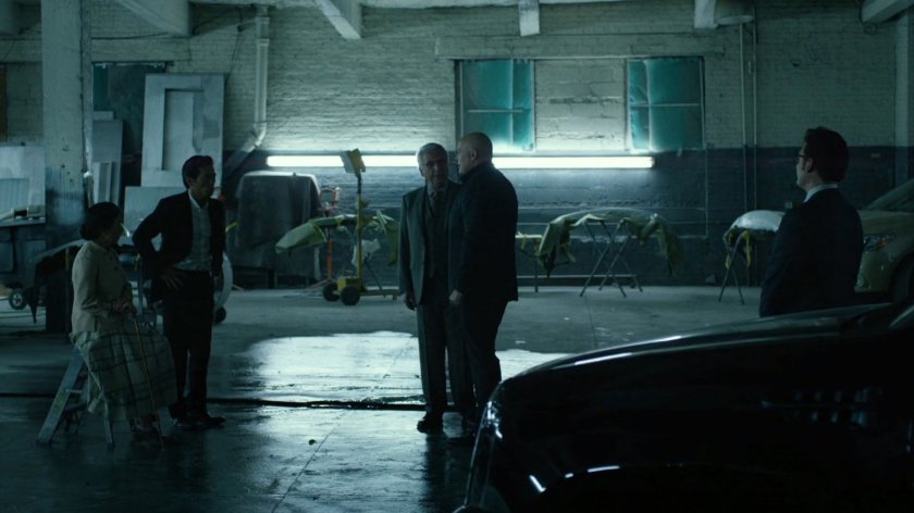 Madame Gao, Nobu, Fisk and Leland in body shop garage.