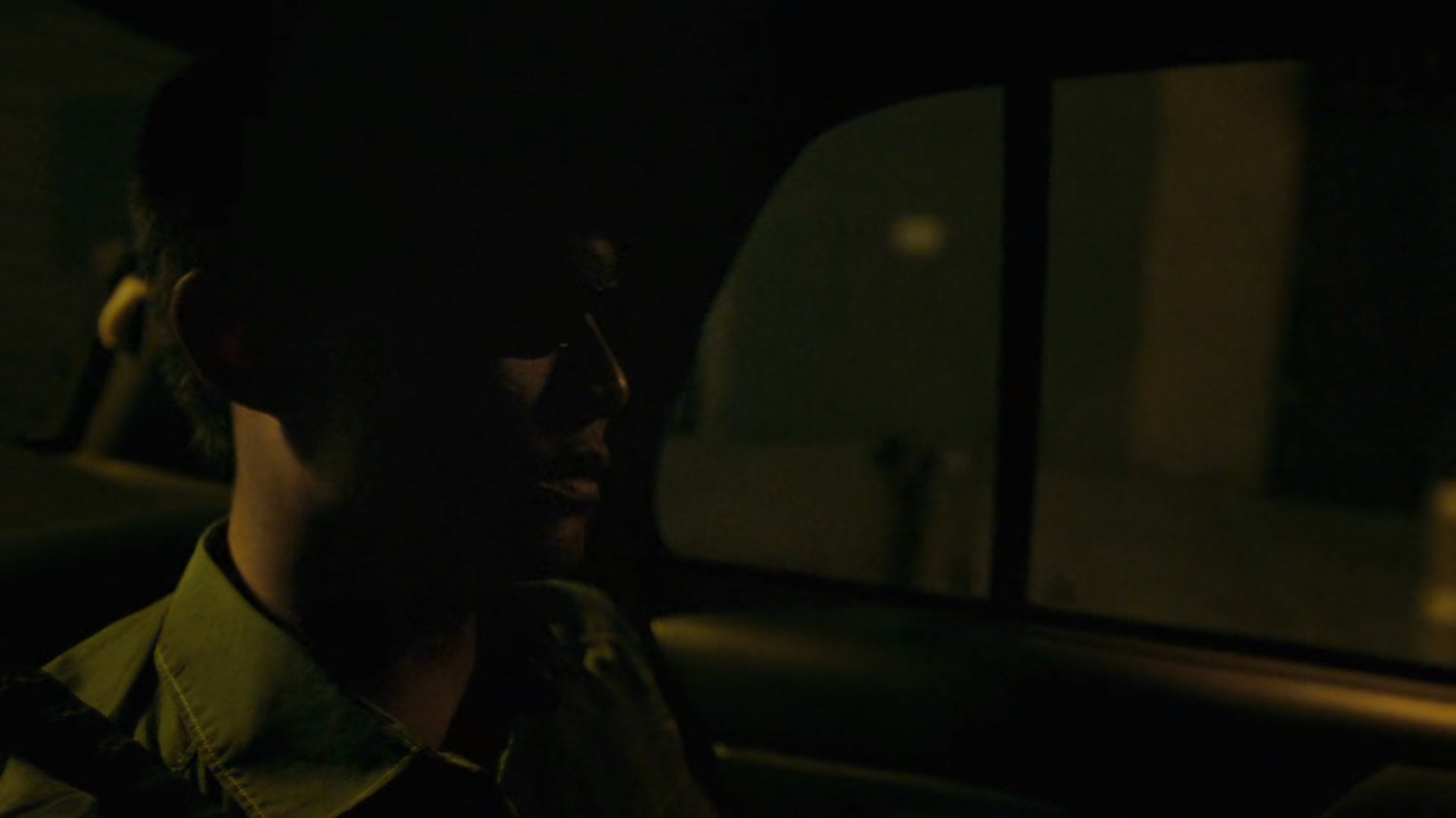 Blind man in back of Russian taxi.