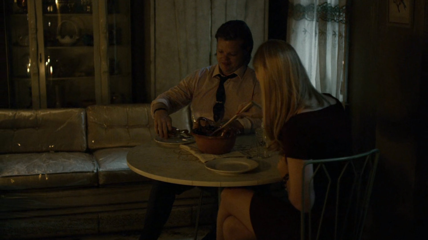 Foggy and Karen eat a meal in Elena Cardenas' apartment.