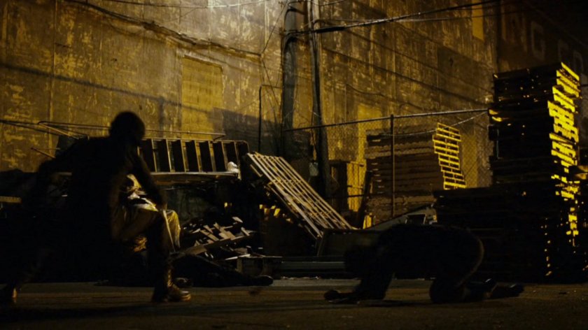 Daredevil and Vladimir fight in pallet yard outside Russian warehouse.